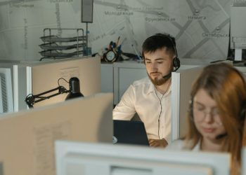 Dedicated call center agents working diligently at their desks in an office.