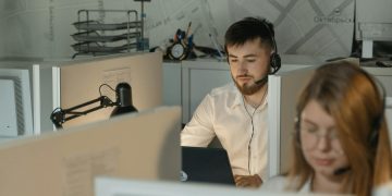 Dedicated call center agents working diligently at their desks in an office.
