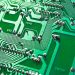 Detailed view of green circuit board with visible chips and pathways, highlighting technology elements.