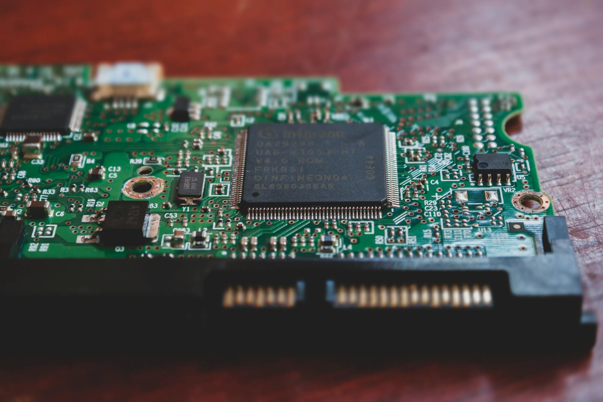Detailed close-up of a green electronic circuit board, highlighting technology components. Shot in Mérida, Venezuela.