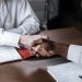 Close-up of a diverse business handshake over documents, symbolizing agreement and collaboration.