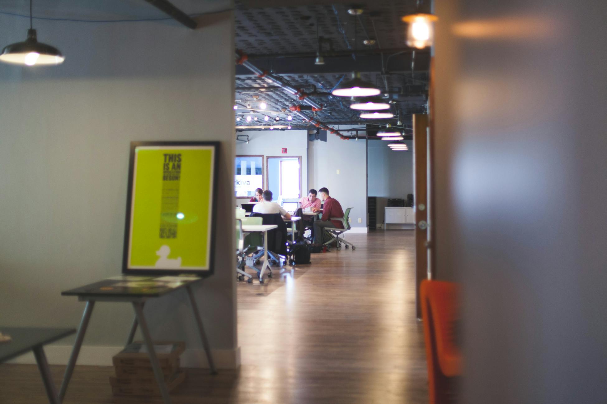 Contemporary open office space with people collaborating and working together.