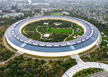 Stunning aerial view of the modern Apple Park in Cupertino, showcasing its unique circular design and lush greenery.