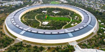 Stunning aerial view of the modern Apple Park in Cupertino, showcasing its unique circular design and lush greenery.