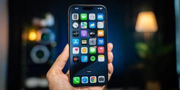 A person holding a cell phone in their hand
