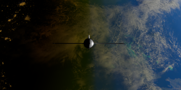 A satellite orbiting Earth showcasing contrasts between ocean and land from space.