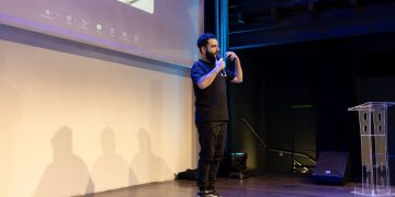 Energetic speaker delivering a talk at a corporate event