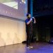 Energetic speaker delivering a talk at a corporate event