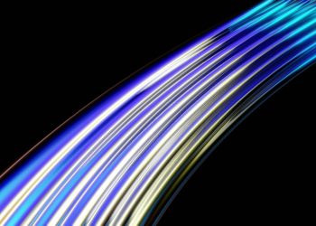 Vibrant curved light trails in blue and yellow on a dark background, depicting speed and technology.