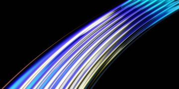 Vibrant curved light trails in blue and yellow on a dark background, depicting speed and technology.