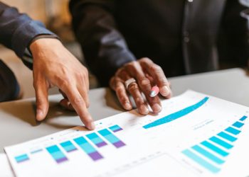 Business professionals analyzing charts and graphs during a meeting.