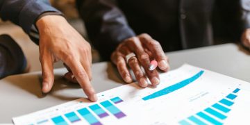 Business professionals analyzing charts and graphs during a meeting.