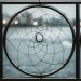 A close-up of an iron railing featuring a circular geometric design, offering a modern abstract aesthetic.