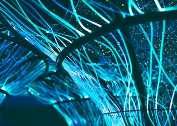 A mesmerizing display of glowing neon blue optical fibers creating a futuristic atmosphere.