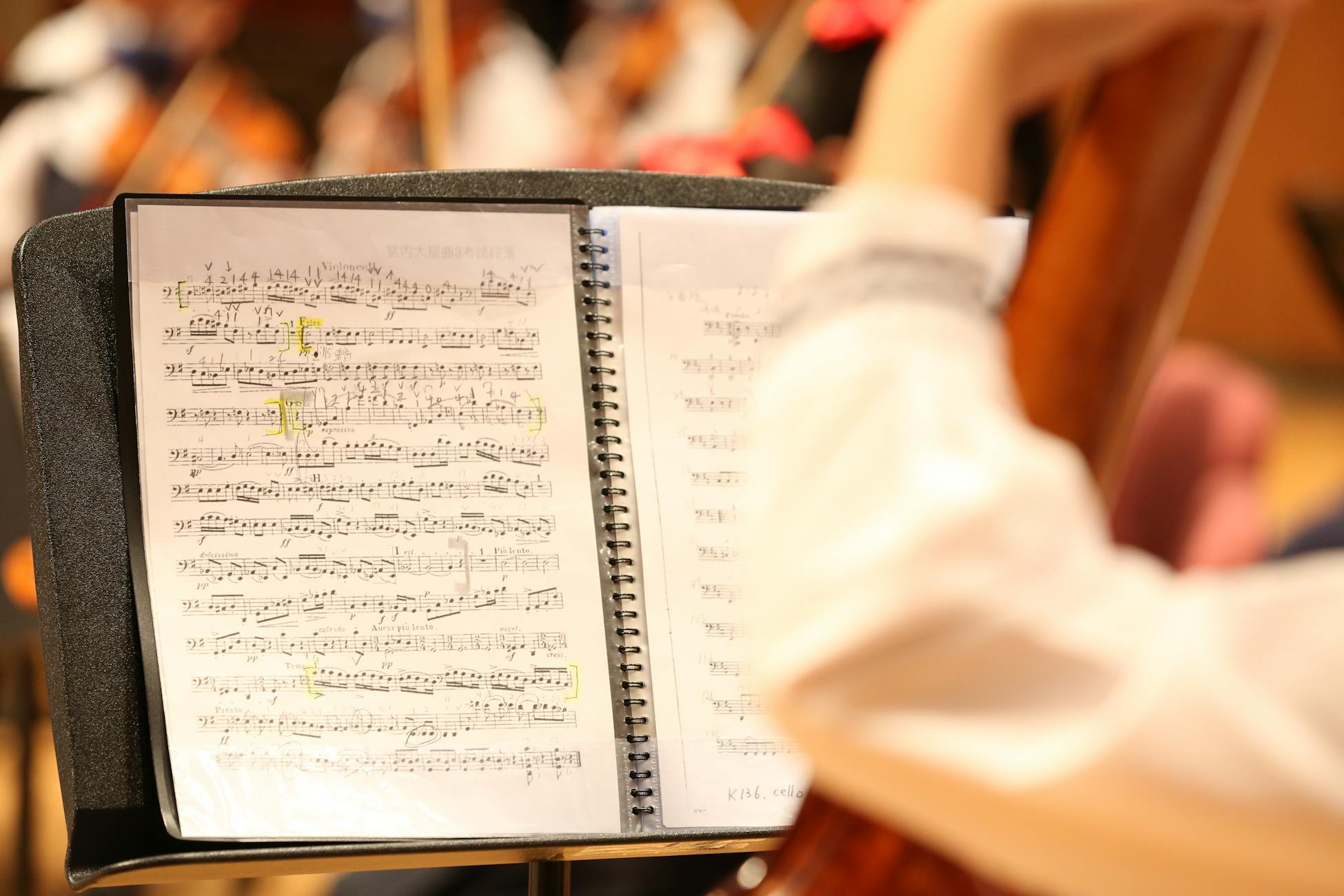 Detailed view of musical notes on sheet music during an orchestra rehearsal.