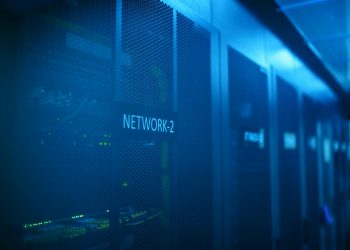 A modern server room featuring network equipment with blue illumination. Ideal for technology themes.