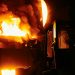 A dramatic scene of molten steel pouring in an industrial setting during nighttime.