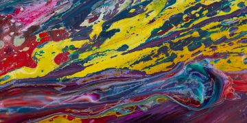Colorful fluid acrylic art showcasing vibrant swirling patterns.