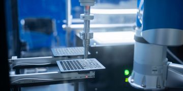 Close-up of robotic arm automating lab processes with precision.