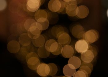 Blurred golden bokeh creating a warm, festive atmosphere, ideal for holiday themes.