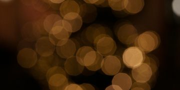 Blurred golden bokeh creating a warm, festive atmosphere, ideal for holiday themes.