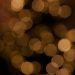 Blurred golden bokeh creating a warm, festive atmosphere, ideal for holiday themes.