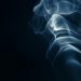 Abstract image of smoke curls set against a dark backdrop, creating an artistic effect.