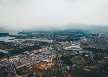 Stunning aerial view of Jiujiang cityscape with sprawling urban and natural landscapes in Jiangxi, China.