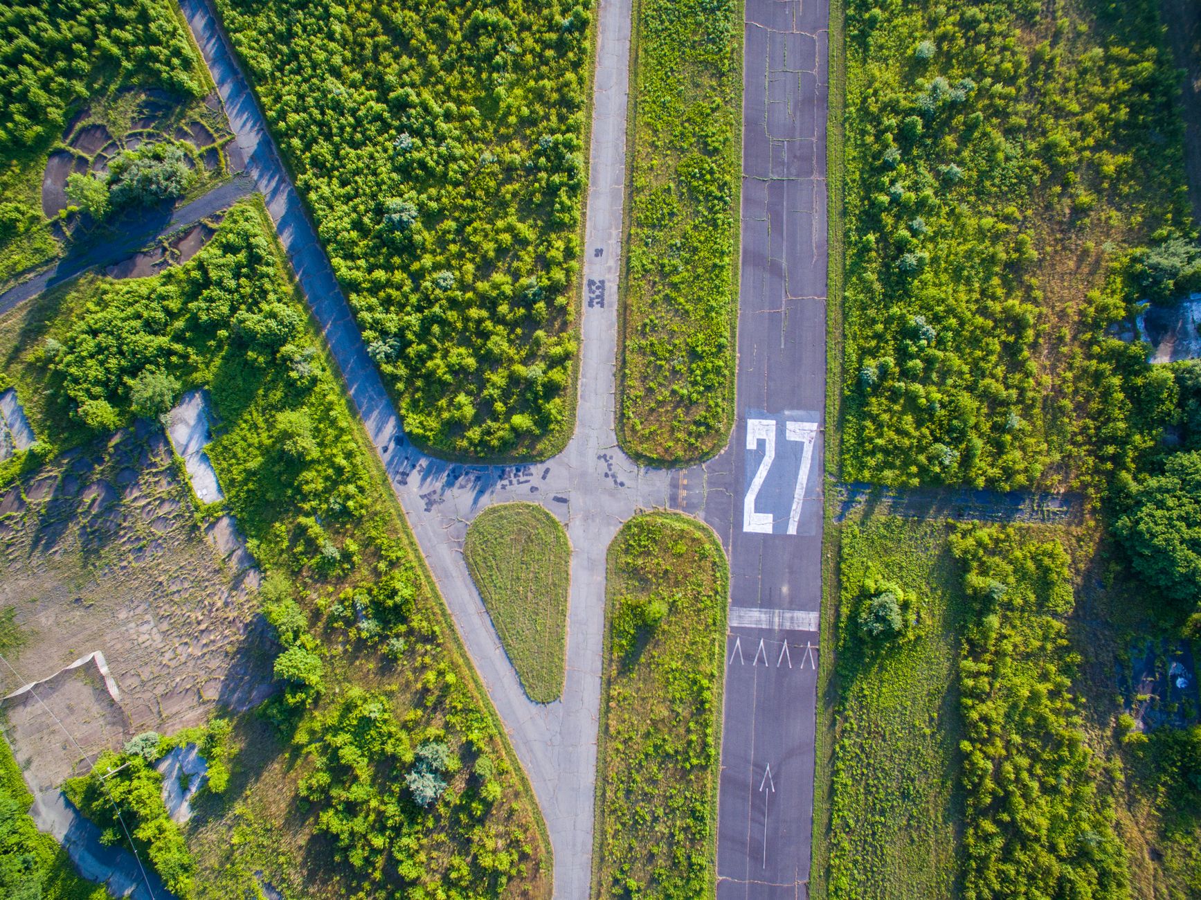 Aerial photo of an abandoned runway surrounded by greenery in Marlboro, NJ.