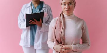 A hopeful cancer patient with a doctor in support during treatment process.