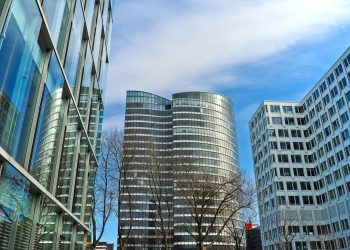 A striking view of modern skyscrapers against a clear blue sky, showcasing contemporary architectural design.
