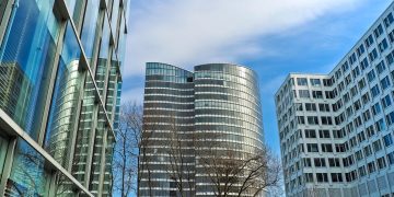 A striking view of modern skyscrapers against a clear blue sky, showcasing contemporary architectural design.