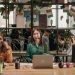 A multicultural group of women working in a modern office setting, showcasing teamwork.