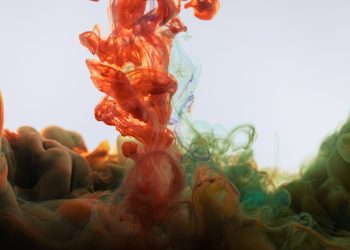 Colorful ink creating mesmerizing patterns in water, highlighting fluid motion and abstraction.