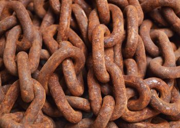 Detailed close-up of rusty metal chains, showcasing texture and pattern.