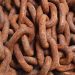 Detailed close-up of rusty metal chains, showcasing texture and pattern.