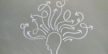 Conceptual chalk drawing illustrating mental health challenges with arrows representing thoughts.