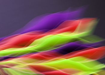 Vibrant abstract image showcasing flowing colors in motion on a dark background.