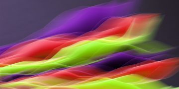 Vibrant abstract image showcasing flowing colors in motion on a dark background.