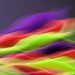 Vibrant abstract image showcasing flowing colors in motion on a dark background.