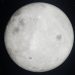 A captivating view of the bright full moon against a starry night sky.