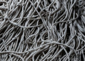 Detailed close-up of gray tangled ropes, perfect for textile and texture backgrounds.