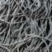 Detailed close-up of gray tangled ropes, perfect for textile and texture backgrounds.
