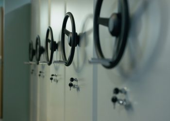 Close-up of industrial safes with manual locks and keys, highlighting security features.