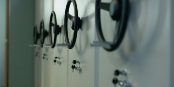 Close-up of industrial safes with manual locks and keys, highlighting security features.