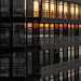 Urban building facade reflecting a beautiful sunset in the windows.