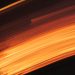 Captivating abstract motion blur with vibrant orange and dark tones, evoking the fluidity and energy of fire.