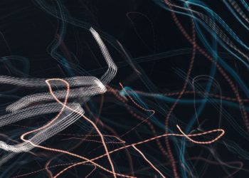 Abstract image showcasing dynamic light trails with motion lines on a dark background.