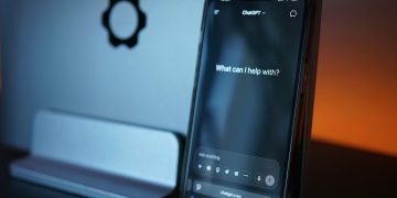 Close-up of a smartphone with AI chat interface, showcasing advanced technology in a sleek design.