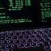 A classic MS-DOS terminal screen displayed on a laptop keyboard with vivid illumination.